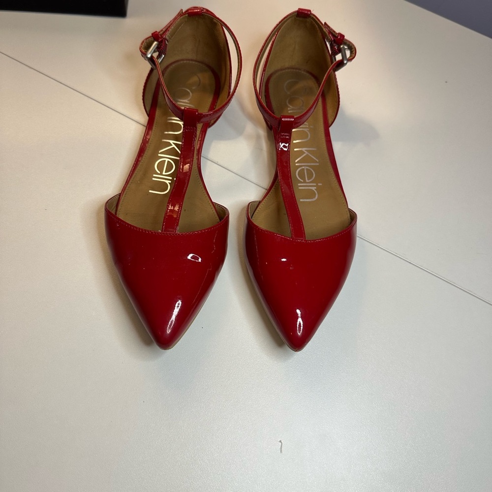 Red Calvin Klein patent leather ballet flats with a T-strap